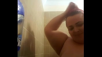 a hairy cute girl stripping and masturbating while take a bath