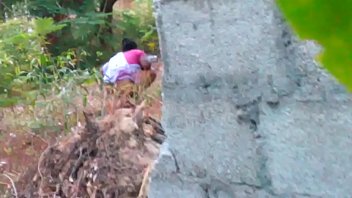 asian female standing peeing toilet